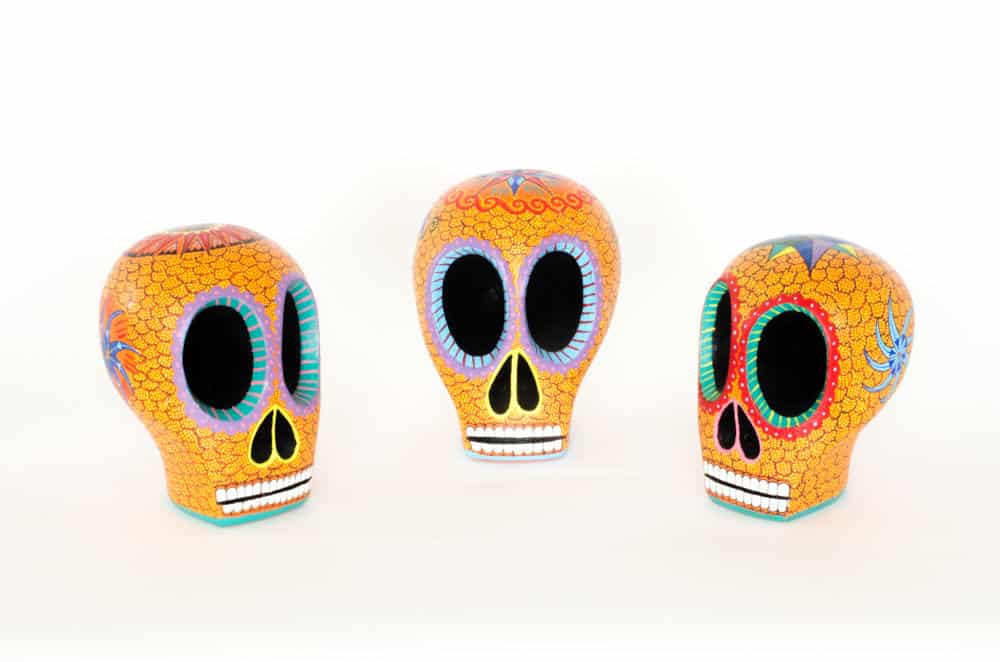 Beautiful hand-carved, hand painted colourful Mexican skulls, known as Calaveras, for Day of the Dead or Halloween. Extraordinary Mexican art from MexArt in London, UK