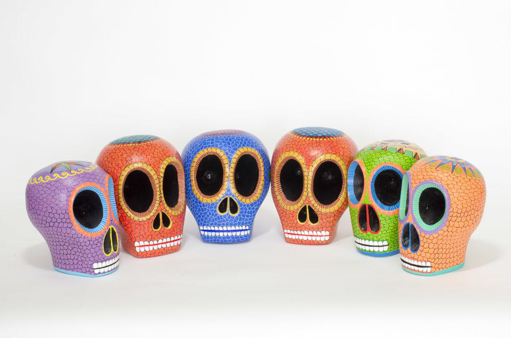 Beautiful hand-carved, hand painted colourful Mexican skulls, known as Calaveras, for Day of the Dead or Halloween. Extraordinary Mexican art from MexArt in London, UK