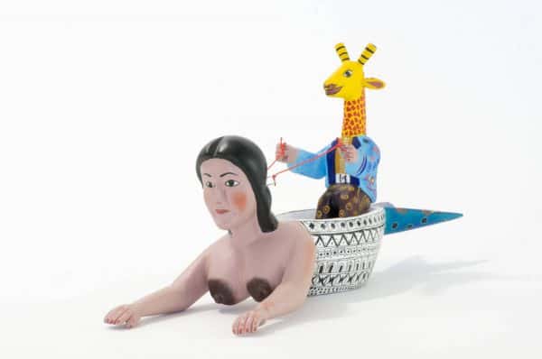 mermaid and giraffe mexican wood carving alebrije A very imaginative Mexican wood carving by Agustin Cruz. This piece has a giraffe with human body sailing a boat with the shape of a mermaid. Extraordinary Mexican art from MexArt, London UK.