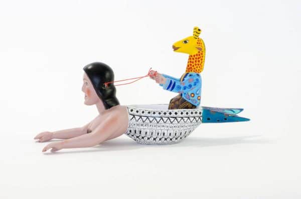 mermaid and giraffe mexican wood carving alebrije A very imaginative Mexican wood carving by Agustin Cruz. This piece has a giraffe with human body sailing a boat with the shape of a mermaid. Extraordinary Mexican art from MexArt, London UK.