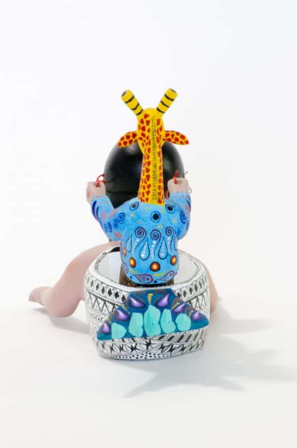 mermaid and giraffe mexican wood carving alebrije A very imaginative Mexican wood carving by Agustin Cruz. This piece has a giraffe with human body sailing a boat with the shape of a mermaid. Extraordinary Mexican art from MexArt, London UK.