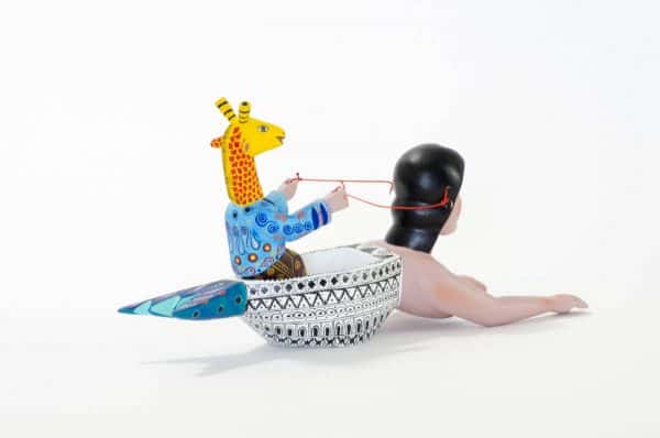 mermaid and giraffe mexican wood carving alebrije A very imaginative Mexican wood carving by Agustin Cruz. This piece has a giraffe with human body sailing a boat with the shape of a mermaid. Extraordinary Mexican art from MexArt, London UK.