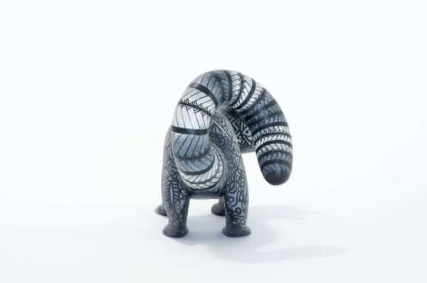 small black and white racoon mexican wood carving alebrije A black and white racoon with captivating eyes by young artist Giovanni Melchor. Extraordinary Mexican art from MexArt, London UK.