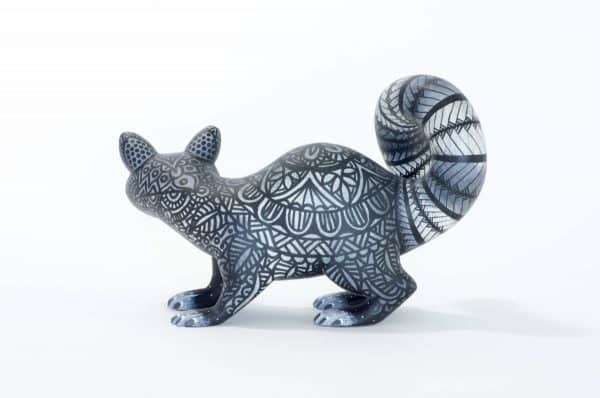 small black and white racoon mexican wood carving alebrije A black and white racoon with captivating eyes by young artist Giovanni Melchor. Extraordinary Mexican art from MexArt, London UK.