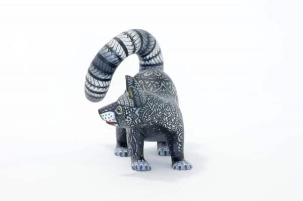 small black and white racoon mexican wood carving alebrije A black and white racoon with captivating eyes by young artist Giovanni Melchor. Extraordinary Mexican art from MexArt, London UK.