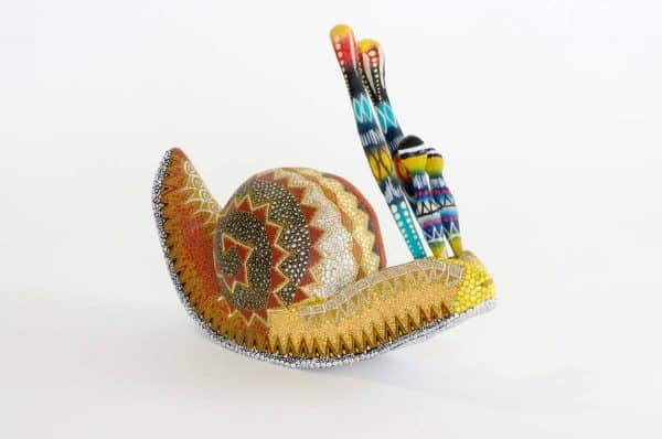 small colourful snail mexican wood carving alebrije A cute and original snail by Pablo and Lucy Mendez. Finely painted with dots creating a very interesting texture. Extraordinary Mexican art from MexArt, London UK.