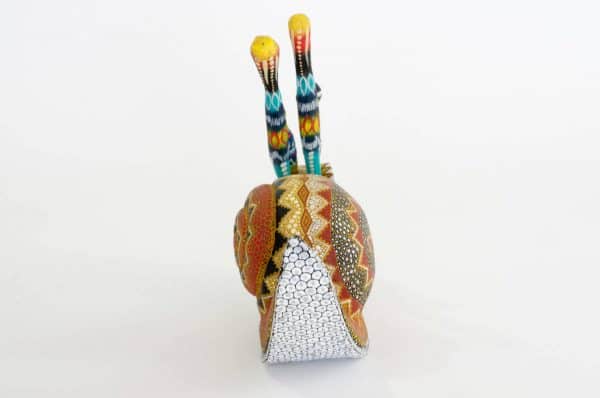 small colourful snail mexican wood carving alebrije A cute and original snail by Pablo and Lucy Mendez. Finely painted with dots creating a very interesting texture. Extraordinary Mexican art from MexArt, London UK.