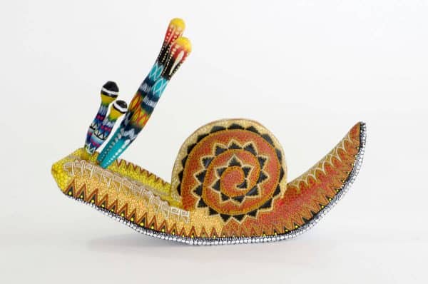 small colourful snail mexican wood carving alebrije A cute and original snail by Pablo and Lucy Mendez. Finely painted with dots creating a very interesting texture. Extraordinary Mexican art from MexArt, London UK.
