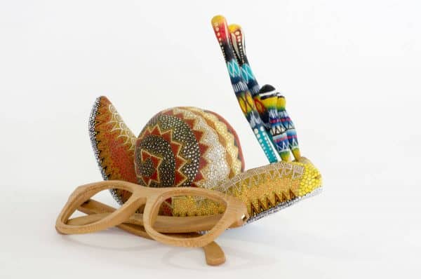 small colourful snail mexican wood carving alebrije A cute and original snail by Pablo and Lucy Mendez. Finely painted with dots creating a very interesting texture. Extraordinary Mexican art from MexArt, London UK.