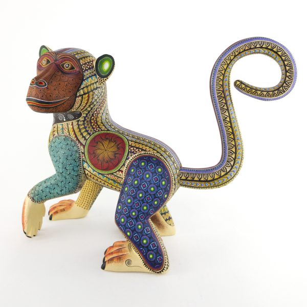 alebrije-large-monkey-brown-yellow-blue Beautiful smiley monkey alebrije painted in delicate patterns. Yellow body, brown face, blue legs and a detachable tail.