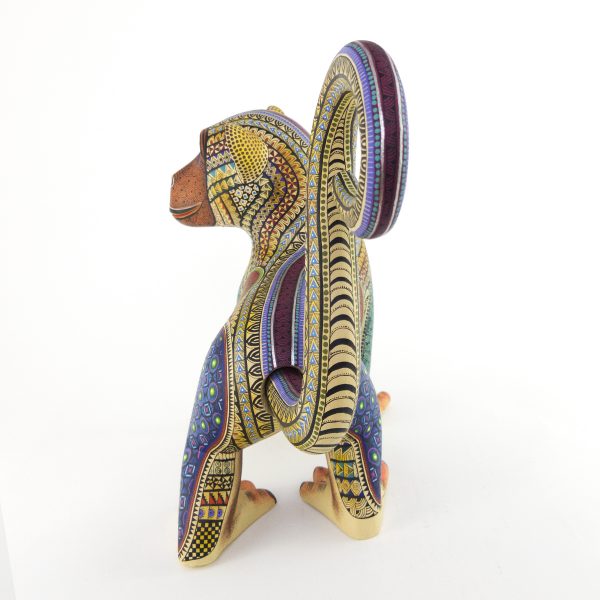 alebrije-large-monkey-brown-yellow-blue Beautiful smiley monkey alebrije painted in delicate patterns. Yellow body, brown face, blue legs and a detachable tail.