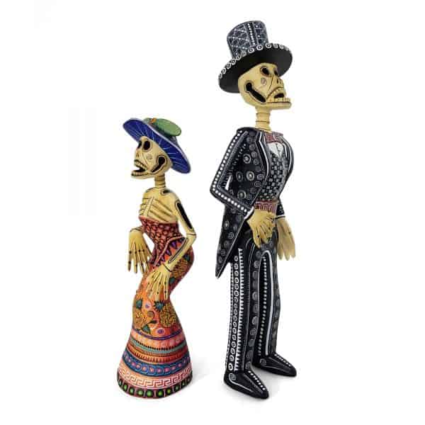 alebrijes-catrin-catrina-skelleton-couple handmade, hand carved pair of elegant skulls representing a catrin and a catrina with hats
